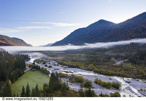 Germany,  Bavaria,  Fog floating over Isar river flowing through forested valley in Wetterstein Mountains