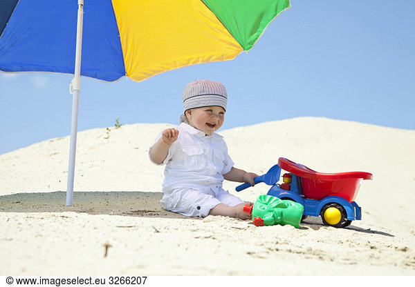 Germany  baby boy (9 months) playing on beach