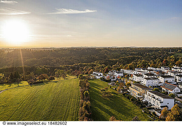 Germany  Baden-Wurttemberg  Baltmannsweiler  Aerial view of modern suburb at autumn sunset