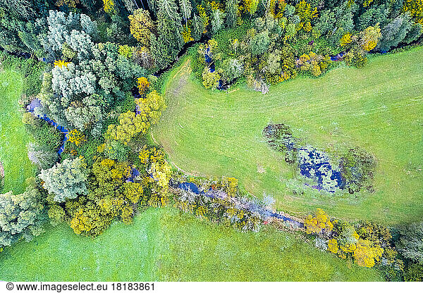 Germany  Baden-Wurttemberg  Drone view of stream flowing at edge of Swabian-Franconian Forest in autumn