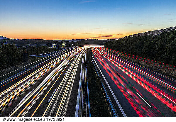 Germany  Baden-Wurttemberg  Kirchheim unter Teck  Vehicle light trails on Bundesautobahn 8 at dusk