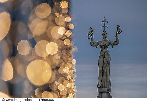 Germany  Baden-Wurttemberg  Konstanz  Statue of Imperia with Christmas lights in foreground