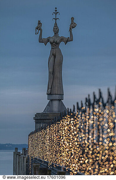 Germany  Baden-Wurttemberg  Konstanz  Statue of Imperia with Christmas lights in foreground