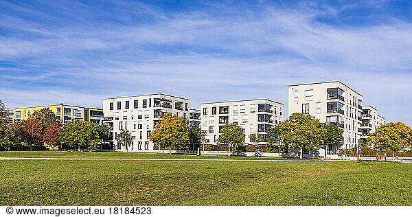 Germany  Baden-Wurttemberg  Ostfildern  Lawn in front of modern apartment buildings in autumn