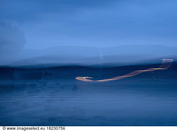 Germany  Baden-Wurttemberg  Radolfzell  Light trails stretching over Lake Constance at blue dusk