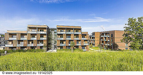 Germany  Baden-Wurttemberg  Stuttgart  Suburban apartment buildings with grass in foreground