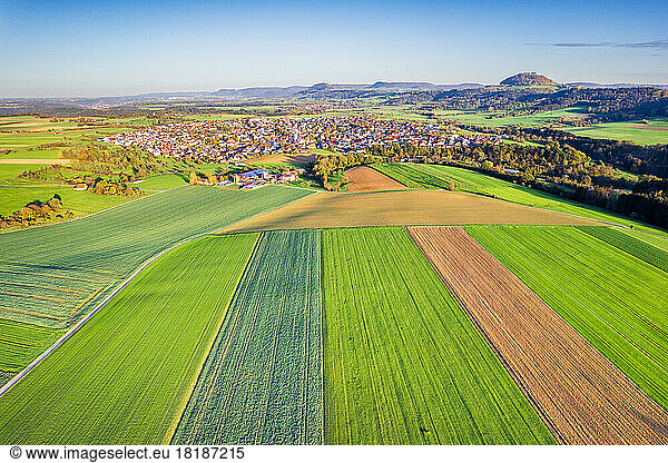 Germany  Baden-Wurttemberg  Waschenbeuren  Drone view of fields and rural town in Swabian Alb