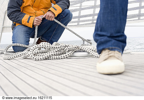 Germany  Baltic Sea  Lübecker Bucht  Man holding rope