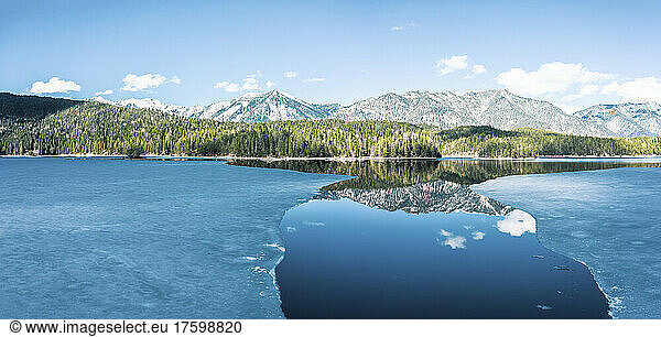 Germany  Bavaria  Aerial view of ice floes thawing in Eibsee lake with Ammergau Alps in background