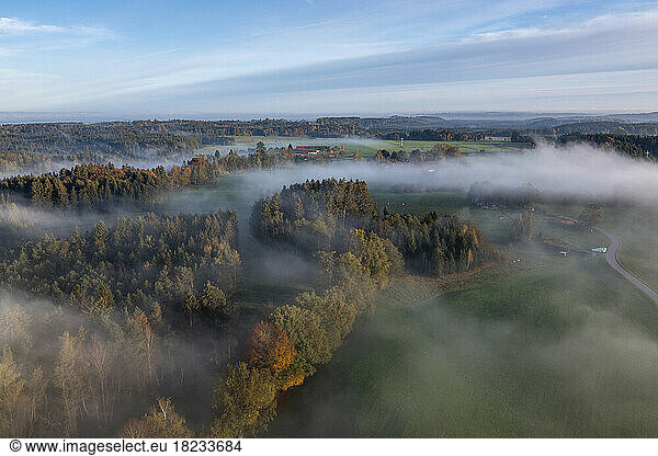Germany  Bavaria  Bad Tolz  Aerial view of autumn forest at foggy dawn