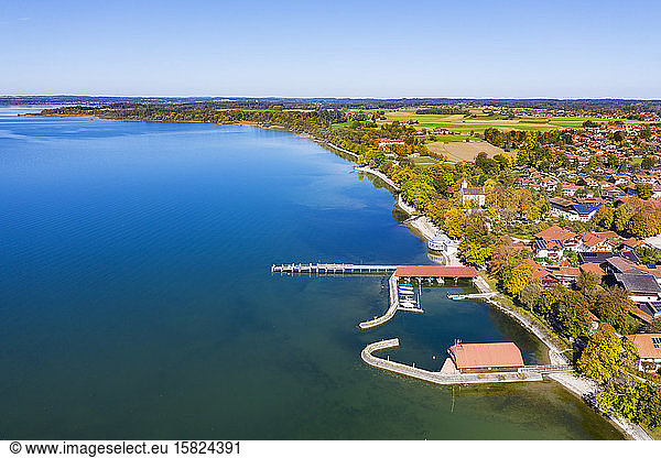 Germany  Bavaria  Chieming  Aerial view of jetty and harbor on shore of Chiemsee lake in autumn