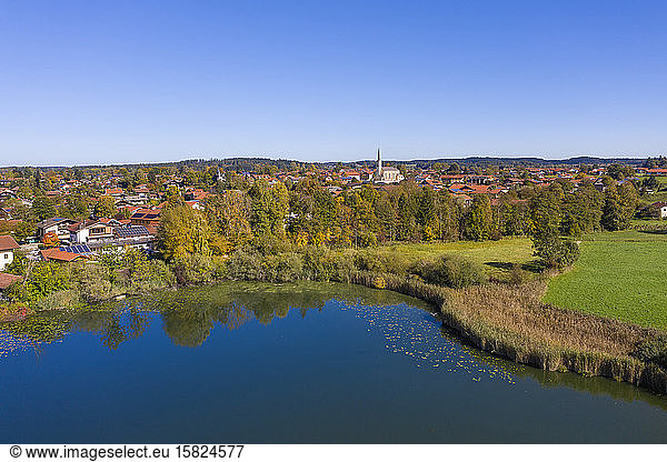 Germany  Bavaria  Chieming  Clear sky over town on shore of Pfeffersee lake in autumn