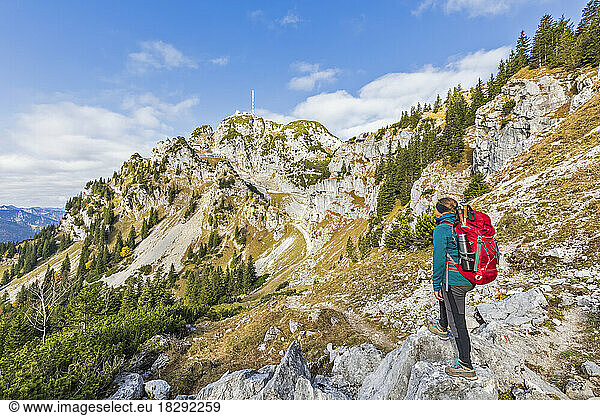 Germany  Bavaria  Female hiker looking toward peak of Wendestein mountain