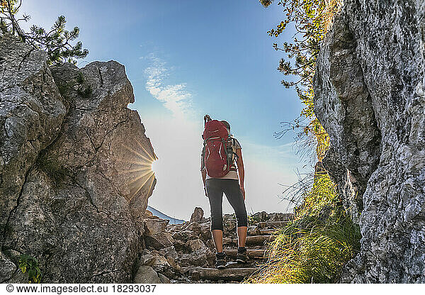 Germany  Bavaria  Female hiker standing on stone steps leading to summit of Rotwand mountain