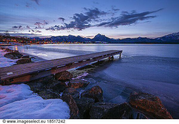 Germany  Bavaria  Fussen  Jetty on shore of Hopfensee lake at winter dawn