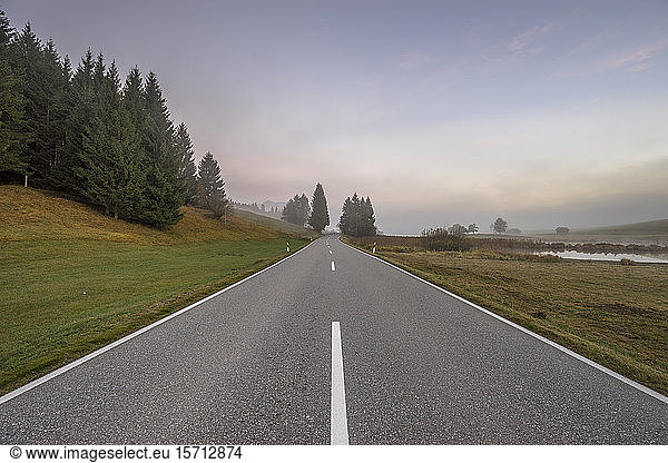 Germany  Bavaria  Garmisch-Partenkirchen  Diminishing perspective of empty highway on autumn morning