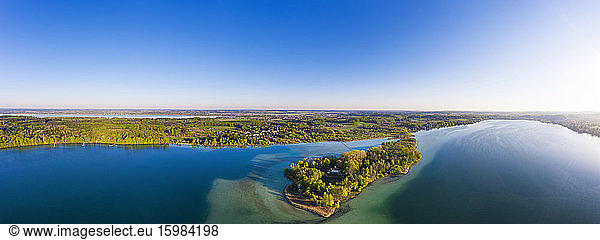 Germany  Bavaria  Inning am Ammersee  Drone panorama of clear sky over forested shore of Worth island