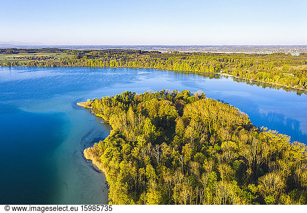 Germany  Bavaria  Inning am Ammersee  Drone view of clear sky over forested shore of Worth island