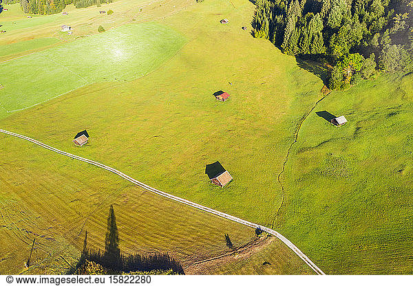 Germany  Bavaria  Krun  Drone view of huts standing in green springtime meadow