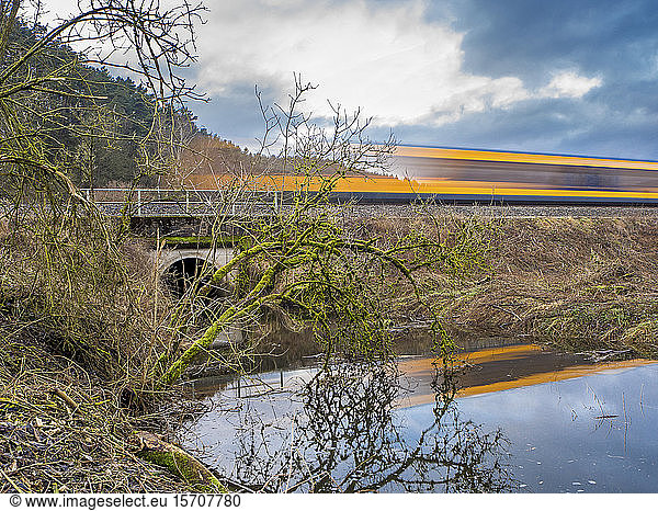 Germany  Bavaria  Long exposure of train passing pond in Upper Palatinate Forest