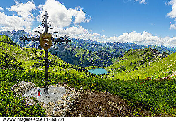 Germany  Bavaria  Memorial cross on Zeigersattel mountain with Seealpsee lake in background