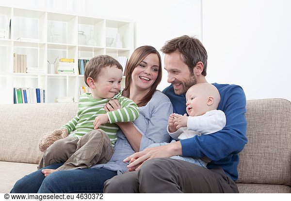 Germany  Bavaria  Munich  Family having fun in living room  smiling
