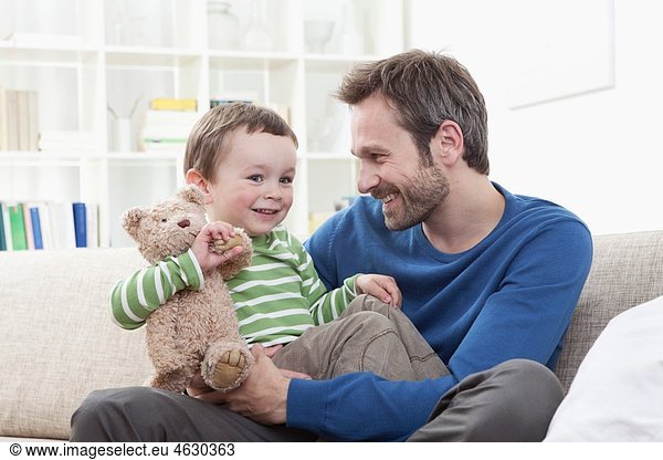 Germany  Bavaria  Munich  Father and son (2-3 Years) with teddy bear  smiling