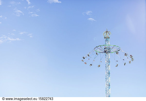 Germany  Bavaria  Munich  Low angle view of Bayern Tower chain swing ride standing against clear sky