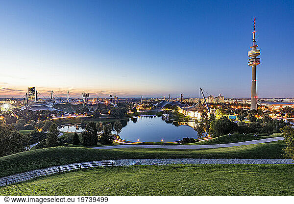 Germany  Bavaria  Munich  Olympic Park at dusk with Olympic Tower  BMW Building and pond in background
