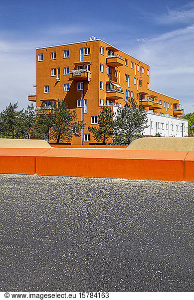 Germany  Bavaria  Munich  Orange painted residential building in Theresienpark