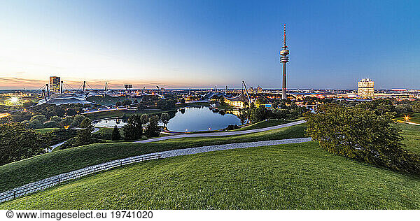 Germany  Bavaria  Munich  Panoramic view of Olympic Park with Olympic Tower  BMW Building and pond in background