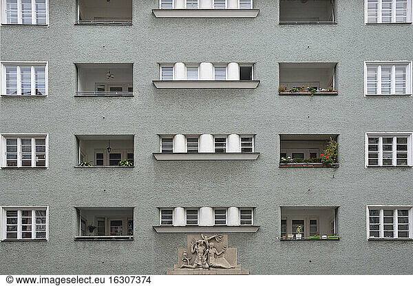 Germany  Bavaria  Munich  part of grey house front with windows  loggias and sculpture
