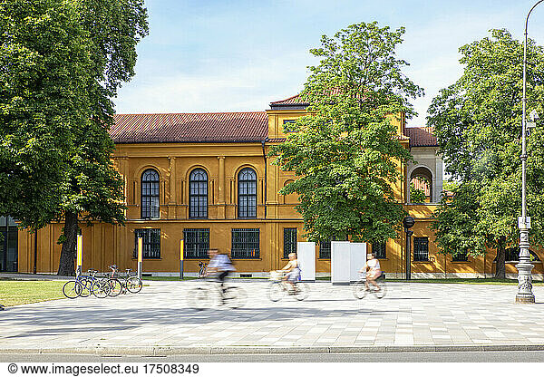 Germany  Bavaria  Munich  People riding bicycles in front of Lenbachhaus museum