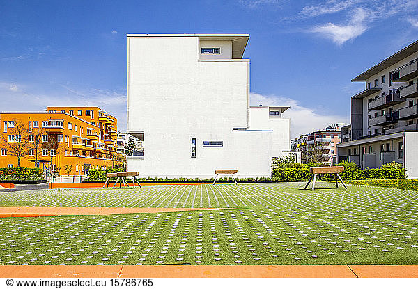 Germany  Bavaria  Munich  Playground with gymnastics vaults in front of residential buildings in Theresienpark