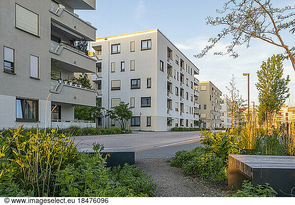 Germany  Bavaria  Munich  Residential garden and surrounding apartments at dusk