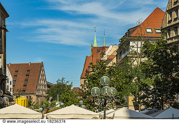 Germany  Bavaria  Nuremberg  Buildings along Konigstrasse with street light and canopies in foreground