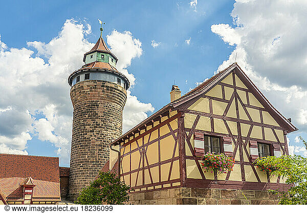 Germany  Bavaria  Nuremberg  Half-timbered house in front of historic Sinwell Tower