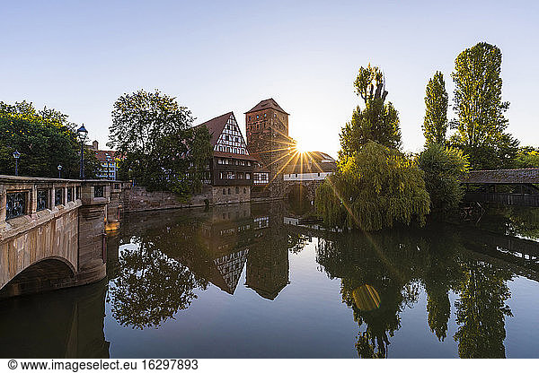 Germany  Bavaria  Nuremberg  Weinstadel and Wasserturm reflecting in river Pegnitz at sunset