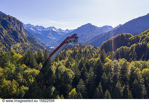 Germany  Bavaria  Oberstdorf  Drone view of Heini-Klopfer-Skiflugschanze ski ramp standing in forested mountain valley