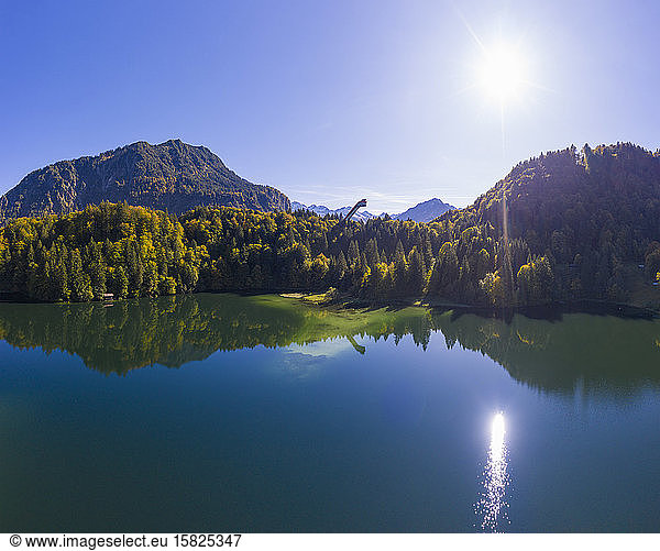 Germany  Bavaria  Oberstdorf  Sun shining over Freibergsee lake and forested mountain valley