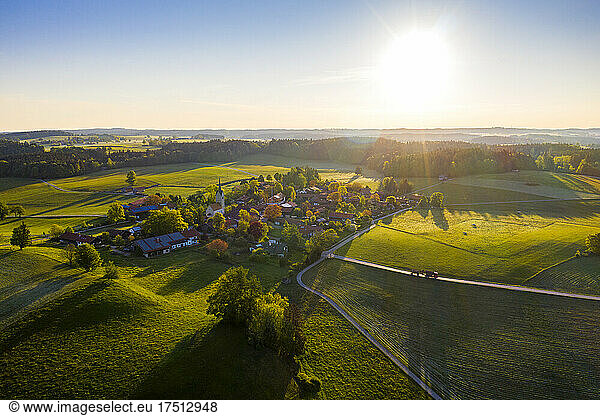Germany  Bavaria  Peretshofen  Aerial view of countryside village at sunset