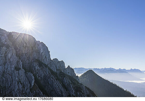 Germany  Bavaria  Sun shining over peak in Bavarian Prealps