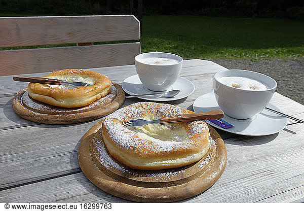 Germany  Bavaria  table of mountain inn with two cups of coffee and two Kniekuechle