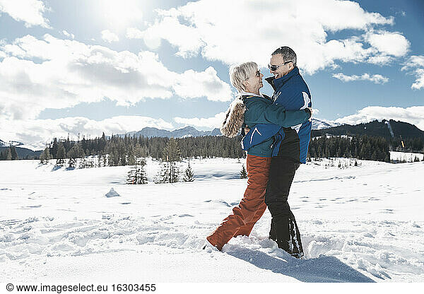 Germany  Bavaria  Winklmoosalm  Mature couple hugging in snow