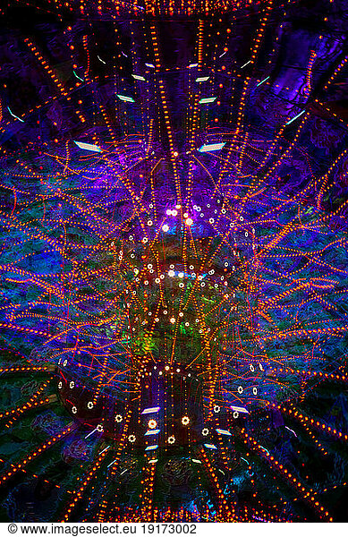 Germany  Bavaria  Wurzburg  Multiple exposure of spinning carousel at night