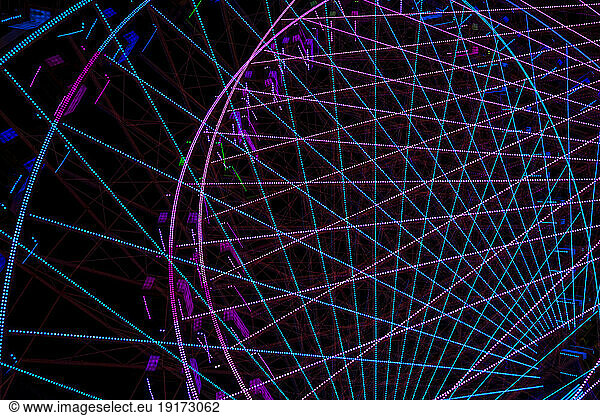 Germany  Bavaria  Wurzburg  Multiple exposure of spinning Ferris wheel at night