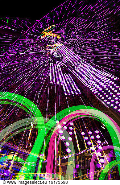Germany  Bavaria  Wurzburg  Multiple exposure of spinning Ferris wheel at night