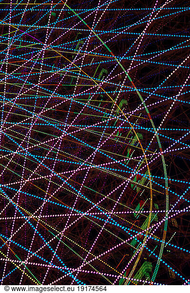 Germany  Bavaria  Wurzburg  Multiple exposure of spinning Ferris wheel at night
