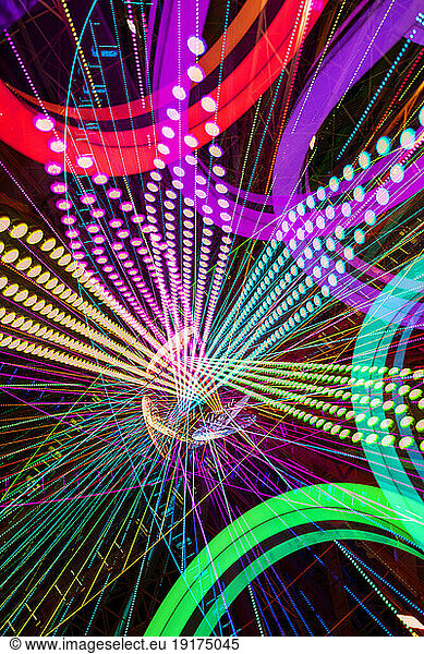 Germany  Bavaria  Wurzburg  Multiple exposure of spinning Ferris wheel at night