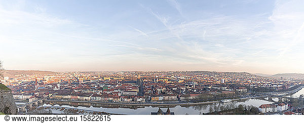 Germany  Bavaria  Wurzburg  Panorama of sky over city river and surrounding buildings at dusk